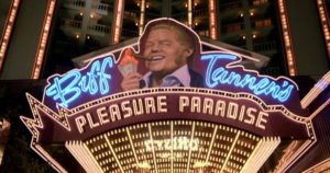 Film still from Back to the Future Part II (1989) featuring the entrance of Biff Tannen’s hotel. His character has been compared to Trump.